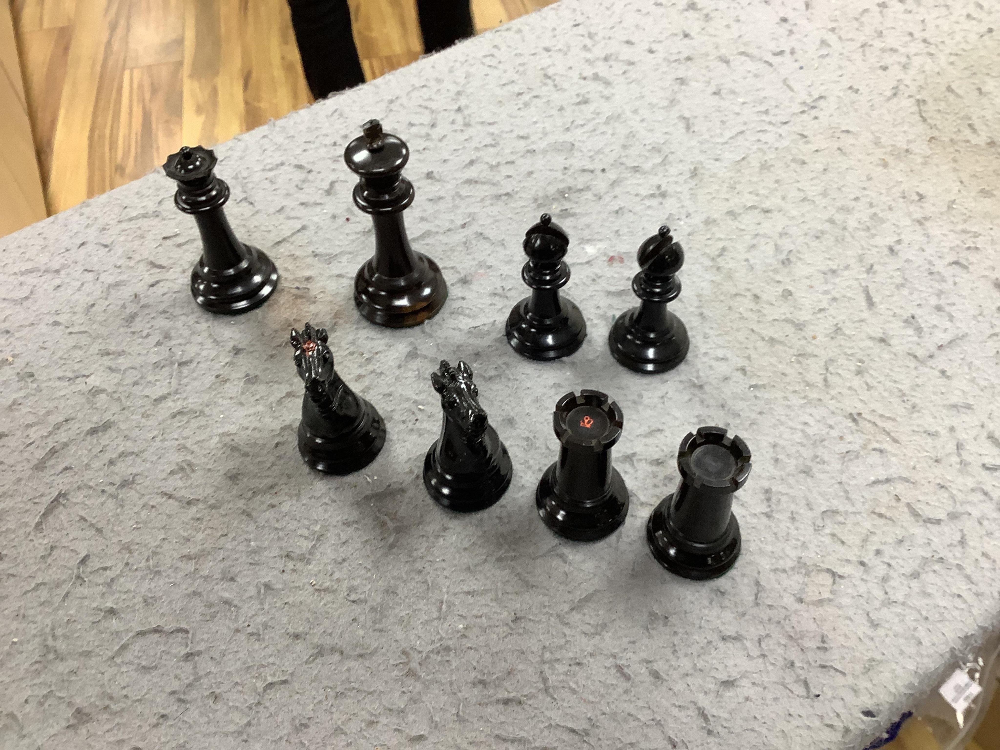 A boxed Jaques Staunton boxwood and ebonised lead weighted chess set, White king stamped Jaques London, Kings 10cm, unlabelled box 20cm wide x 9cm high. Condition - chess pieces good, box cracked